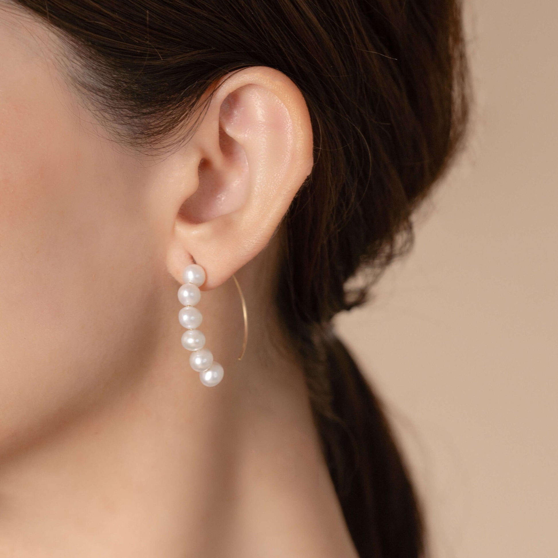 Elegant white pearl earrings crafted from lustrous white pearls, perfect for adding a touch of sophistication to any outfit.