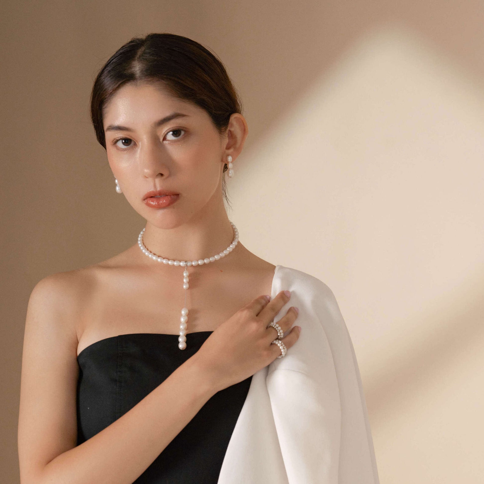 Add a touch of sophistication with a woman wearing a pearl necklace and earrings. Classic chic!