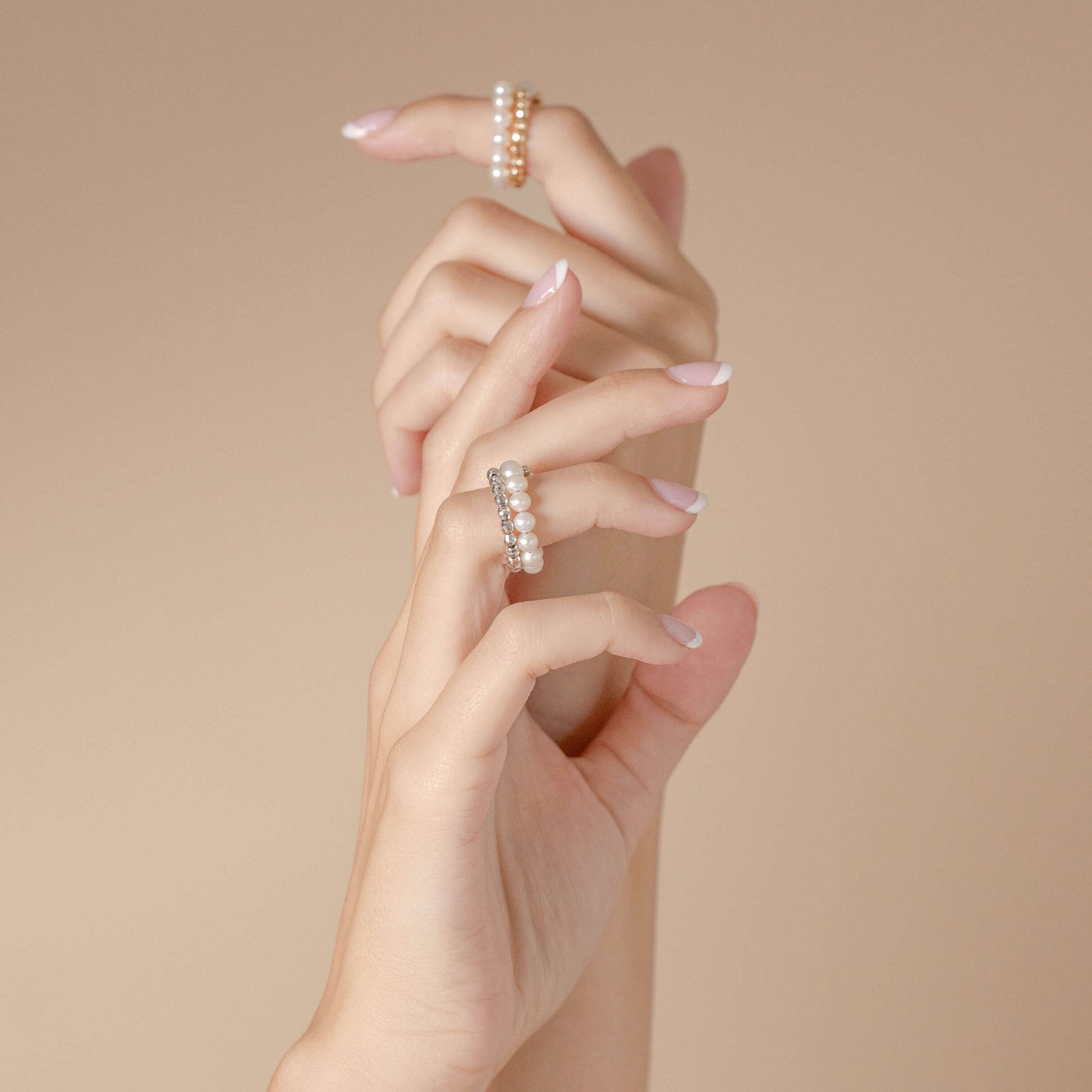Enhance your elegance with Spiral Pearl x White Gold Ring adorning a woman's hands.