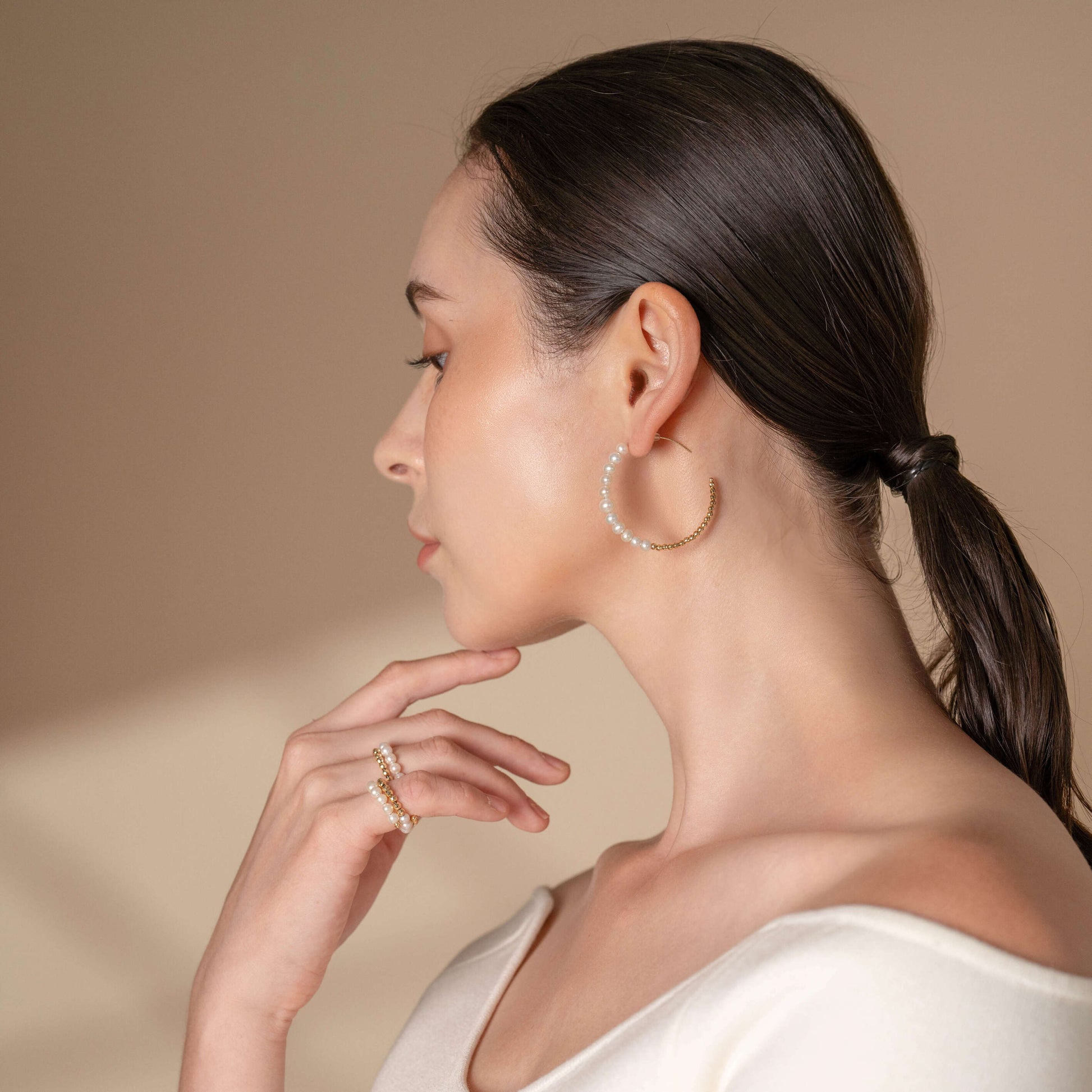 Elegant lady wearing white top and Mirror Gold x Pearl Hoop Pierce earrings.