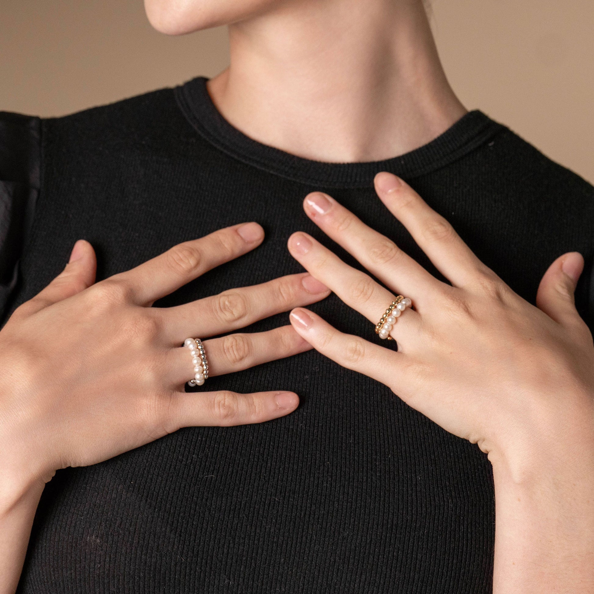 Elevate your style with the captivating Spiral Pearl x Gold Ring, gracefully showcased on a woman's hands.