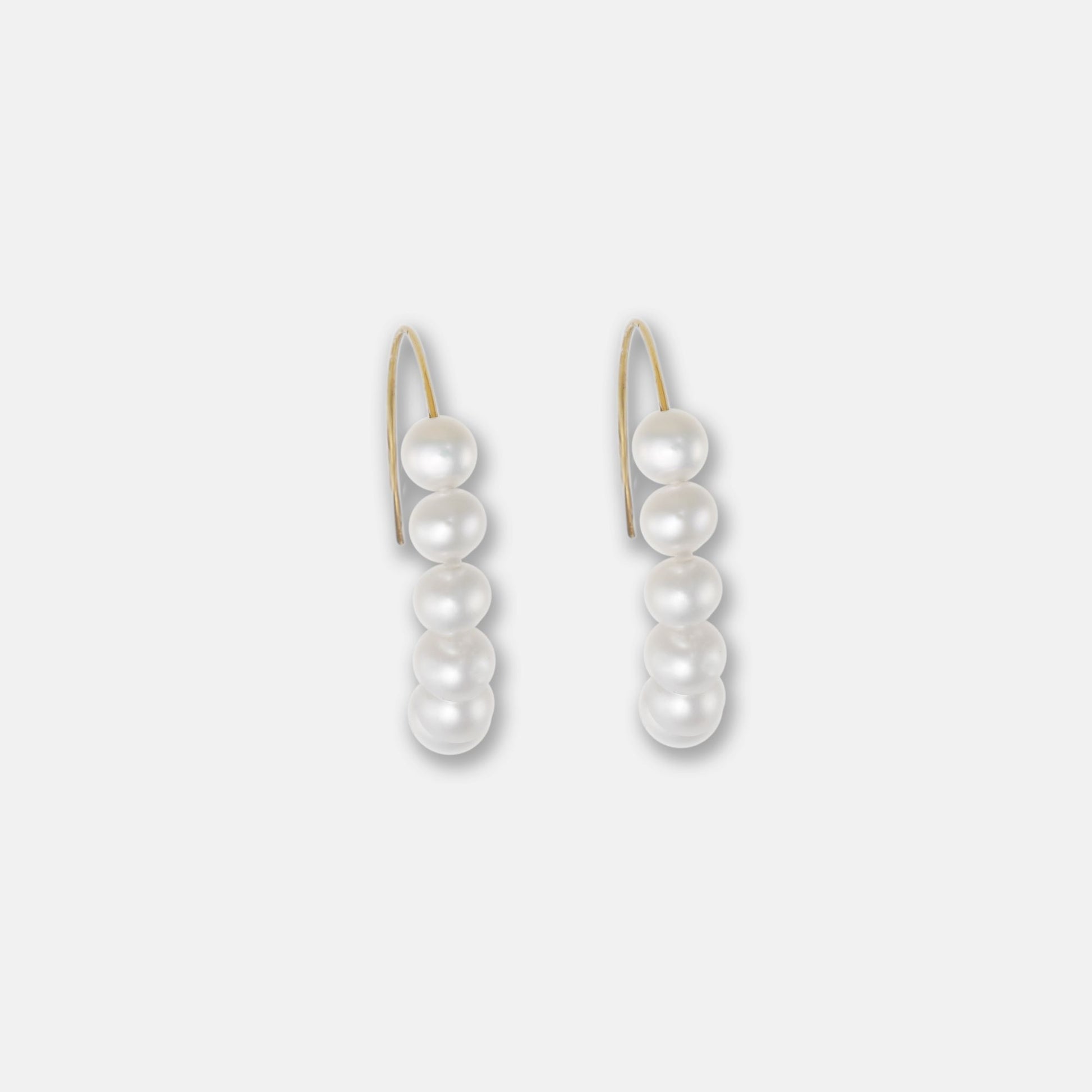 Gilded in gold, these pearl hoop earrings epitomize luxury. The delicate pearls add a touch of refinement, making them a must-have accessory.
