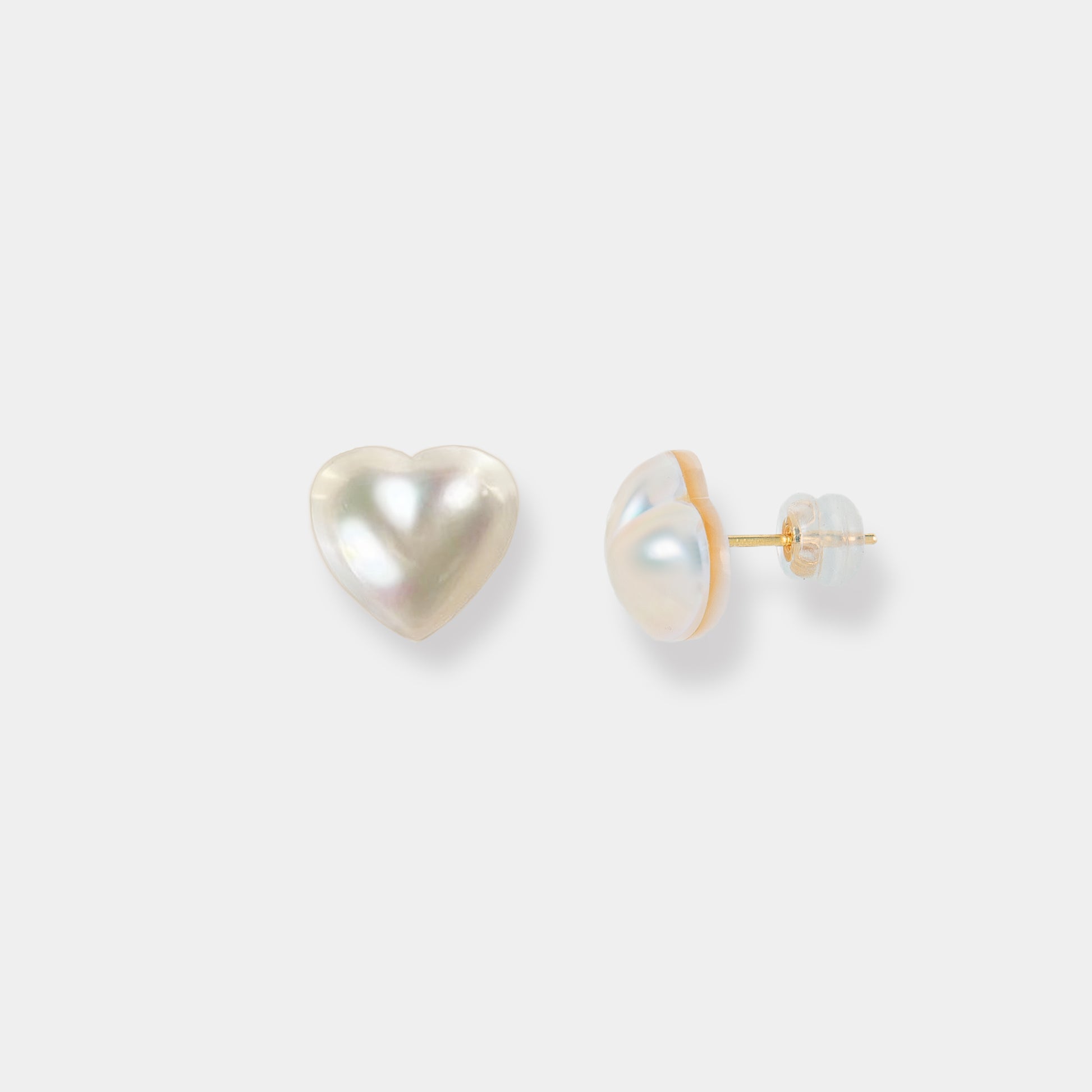 Elevate your style with these stunning white heart-shaped pearl stud earrings. A timeless accessory that adds a touch of sophistication.