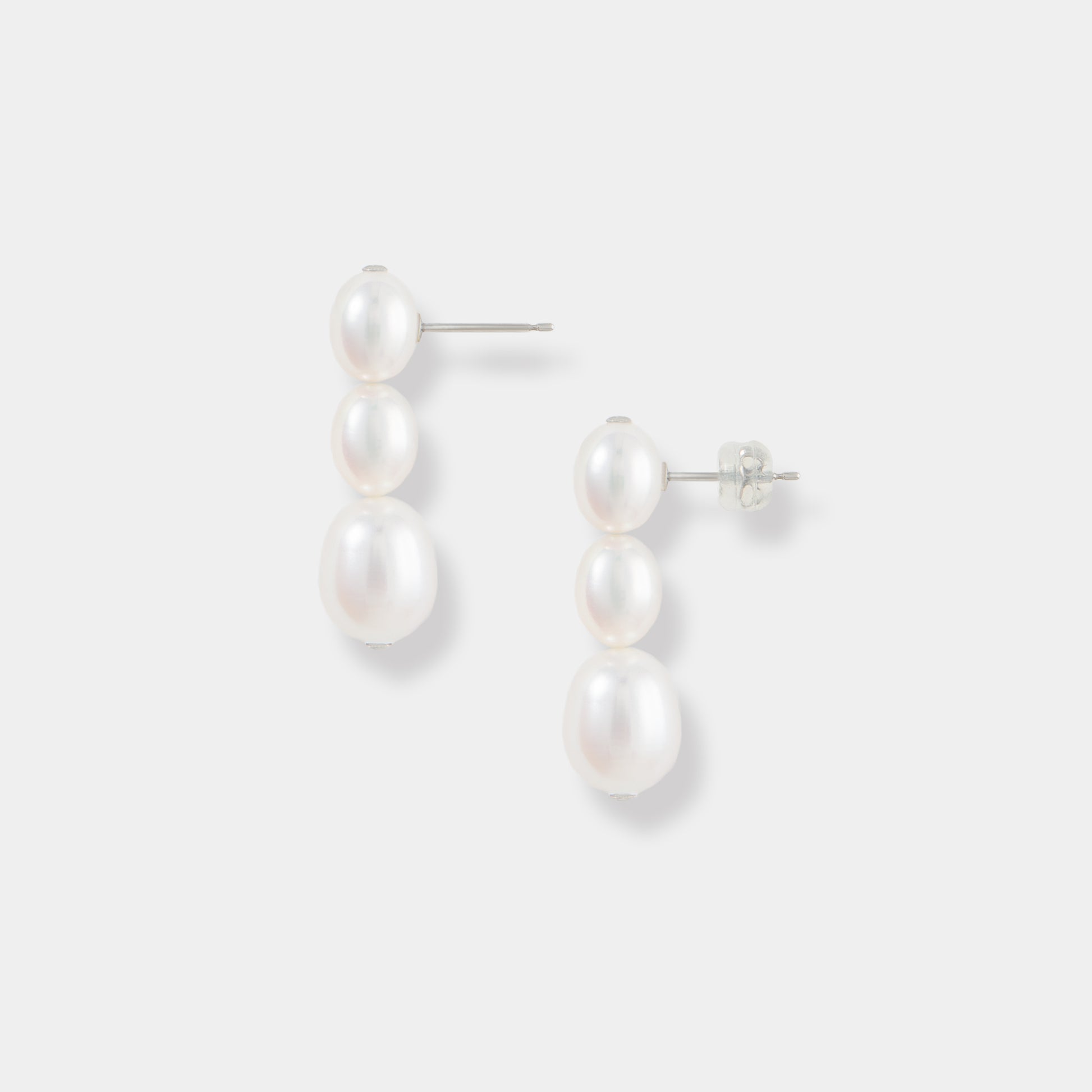 Experience sophistication with these elegant pearl drop earrings showcased on a pure white background. A touch of luxury.