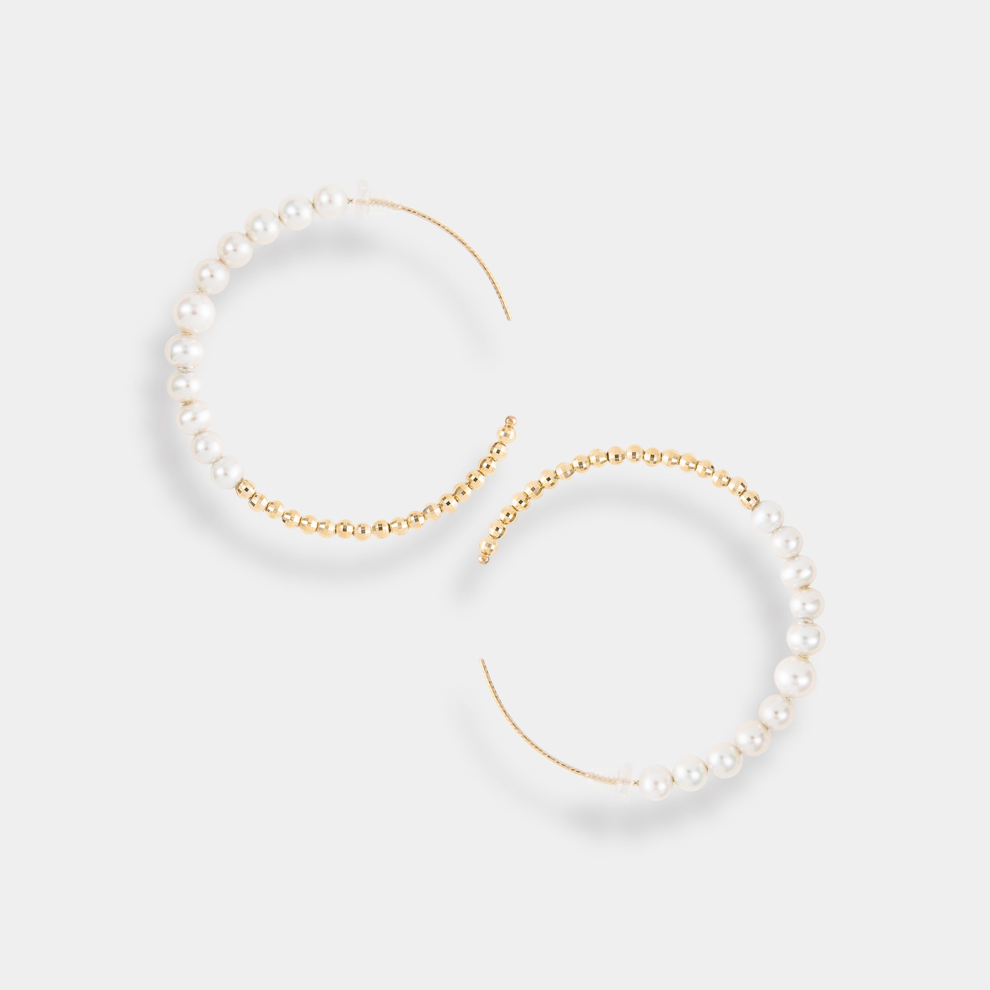 Luxurious gold hoops adorned with beautiful pearls, a must-have accessory for a glamorous look.