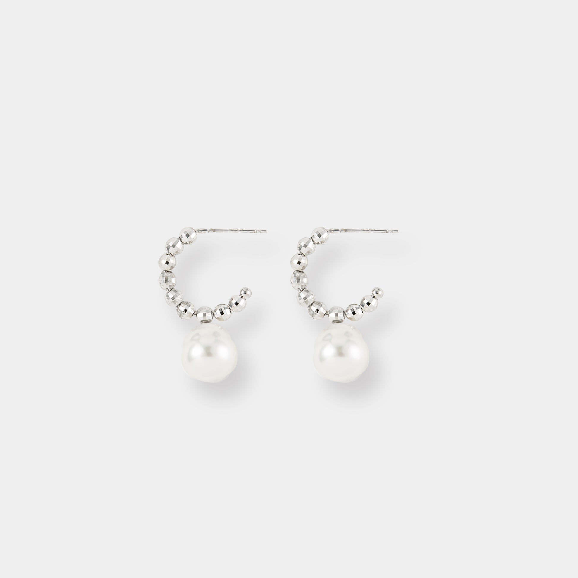 Indulge in timeless beauty with these stunning white pearl and white gold beads earrings. Elevate your style effortlessly.