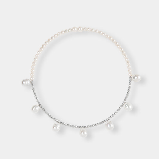 Elegant pearl and white gold bead necklace on white background, perfect for adding a touch of luxury to any outfit.