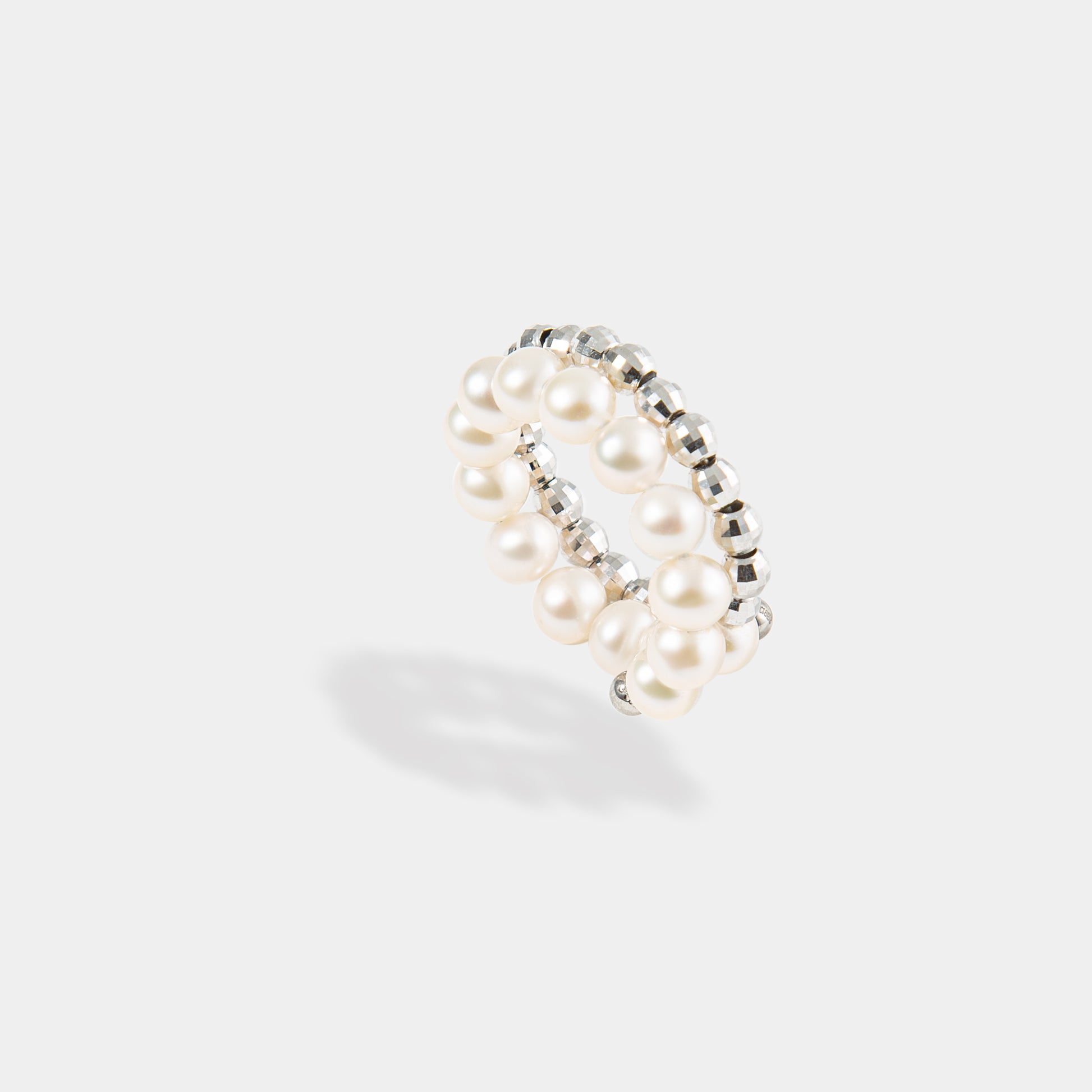 Elevate your look with our stunning Spiral Pearl x White Gold Ring, a timeless accessory that exudes grace and beauty.
