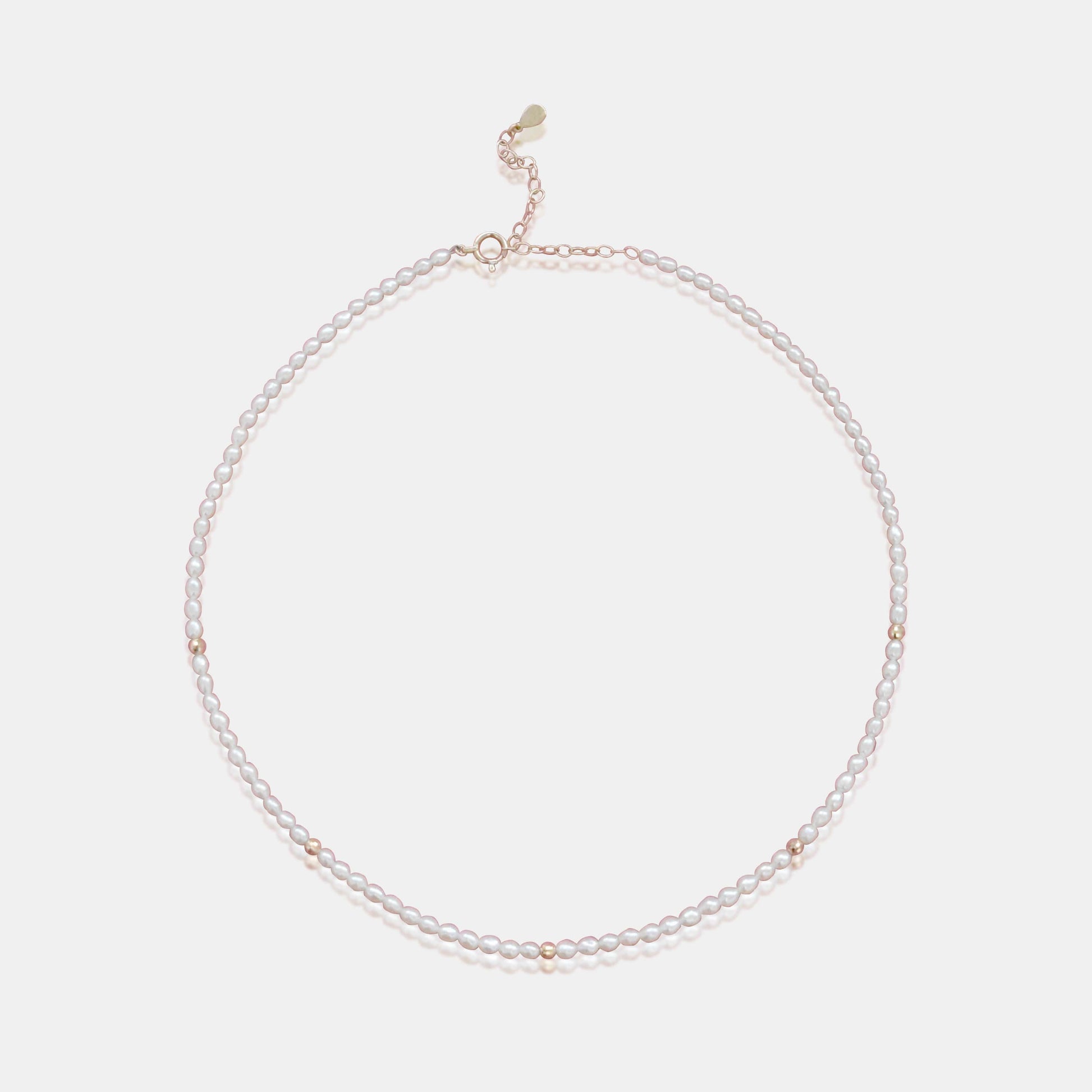 Embrace timeless beauty with the Amore Necklace - a graceful white pearl necklace complemented by exquisite gold beads.