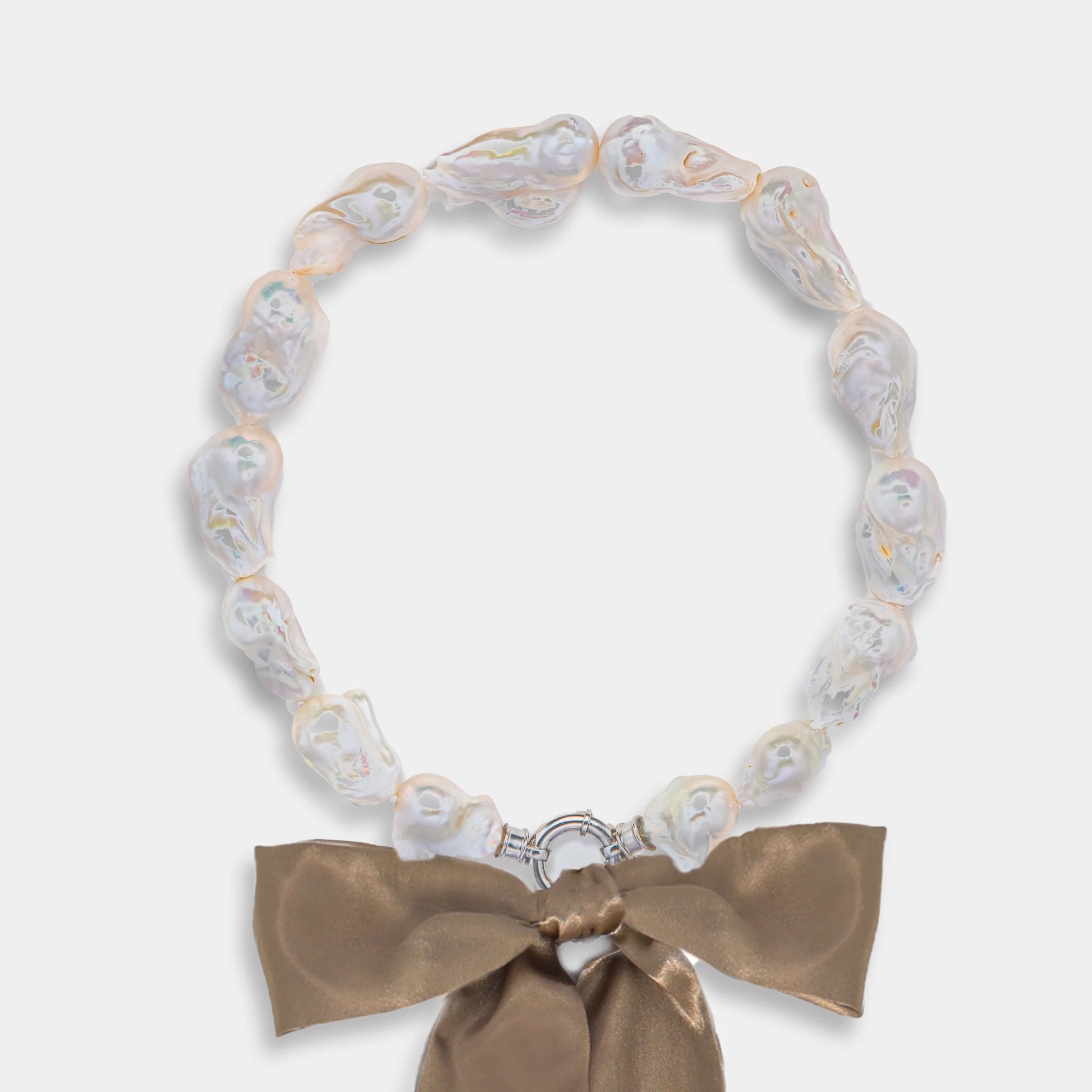 Elegant necklace with bow paired with Ribbon Baroque Pearl Necklace.
