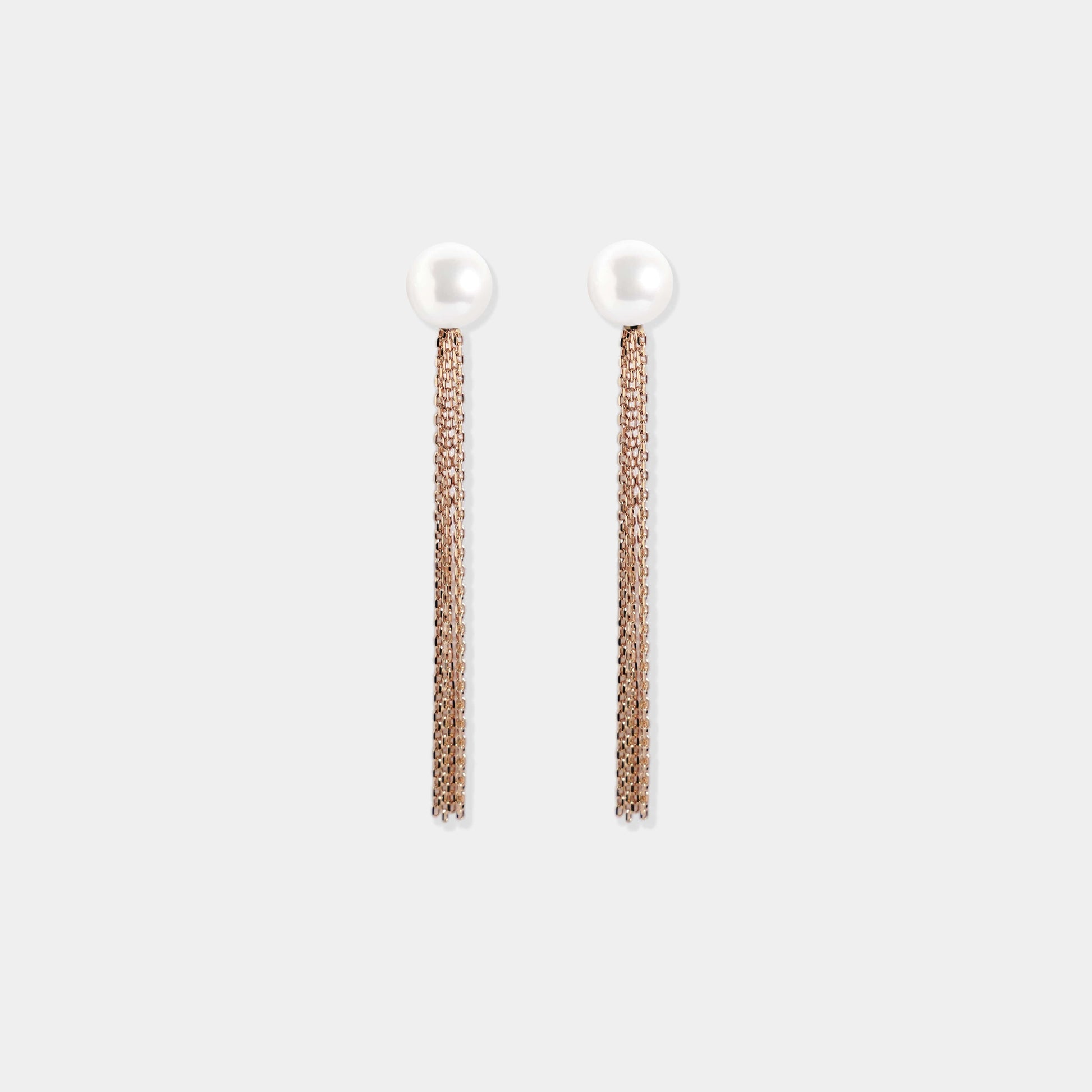 Luxurious white pearl earrings with gold accents, set on a pristine white background. A must-have for any fashionista.