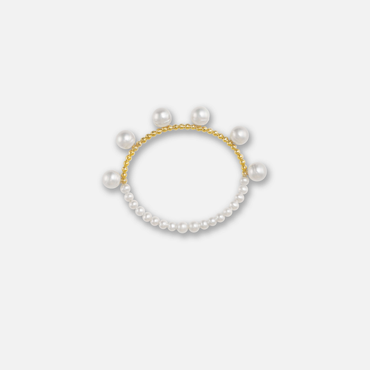 Elegant pearl bracelet with gold beads on a white background. Perfect for adding a touch of sophistication to any outfit.
