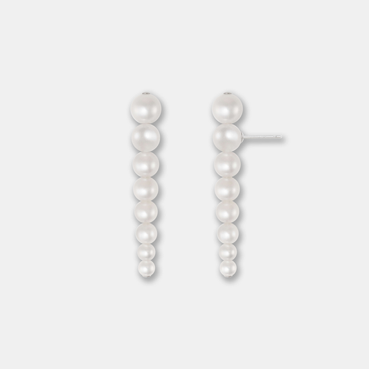 Enhance your elegance with Stella Piercing's exquisite pearl earrings on a pristine white background.