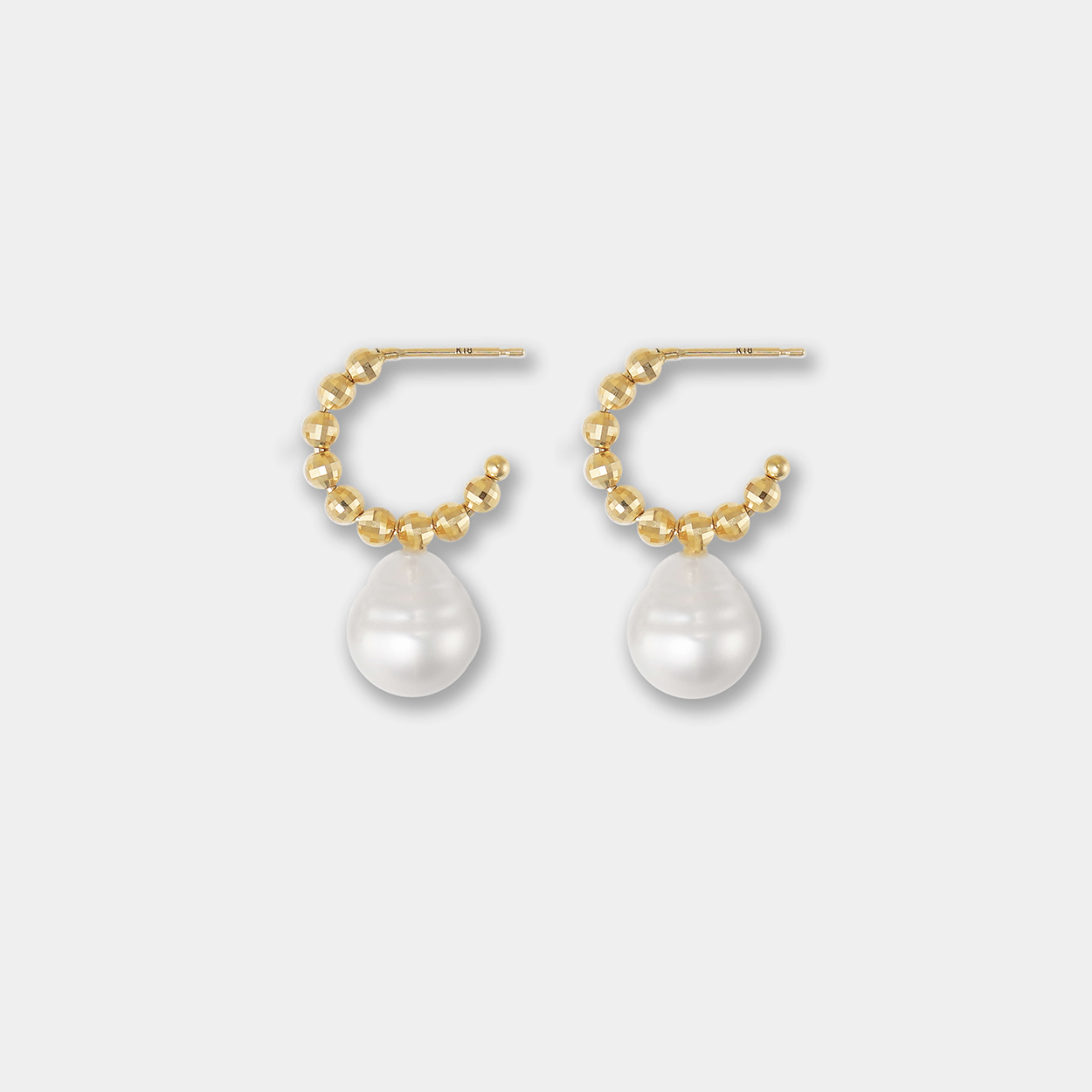 Embrace timeless beauty with these captivating Pearl Dot x Gold Piercing earrings, showcasing a delicate pearl delicately nestled in shimmering gold.