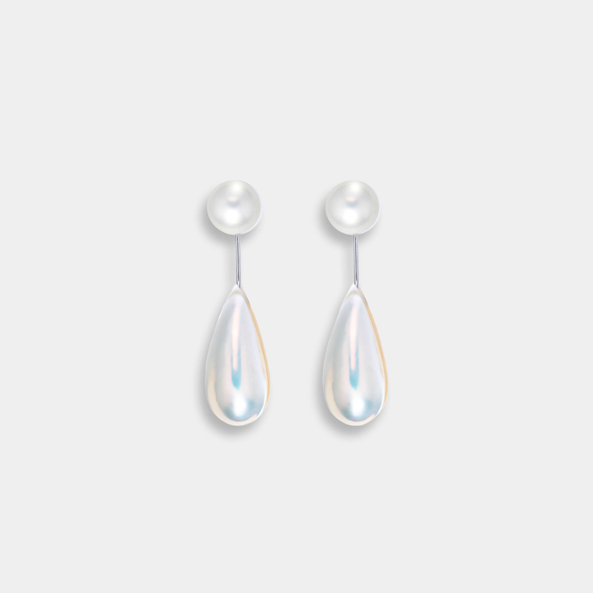 Enhance your look with elegant white pearls on Drop Mabe Pearl Piercing earrings.