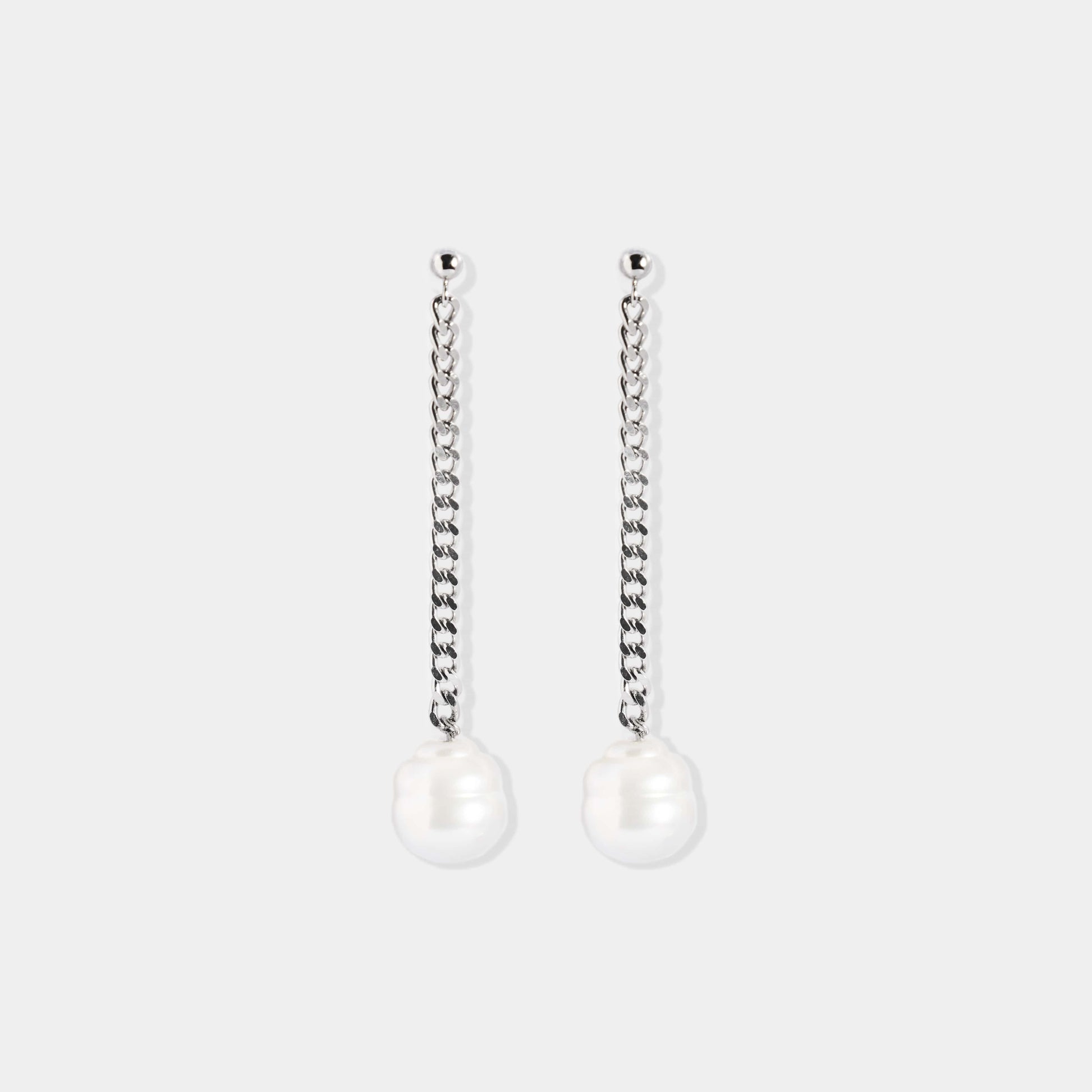 Elevate your style with these stunning white pearl earrings, adorned with a graceful chain. Add a touch of glamour to your look effortlessly!