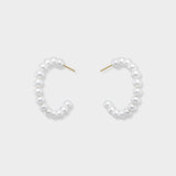 Elegant pearl hoop earrings, meticulously adorned with a continuous row of radiant pearls forming a graceful C-shape. These versatile hoops offer a fresh take on classic pearls, perfect for everyday luxury or special occasions. Make them yours and shine brighter!