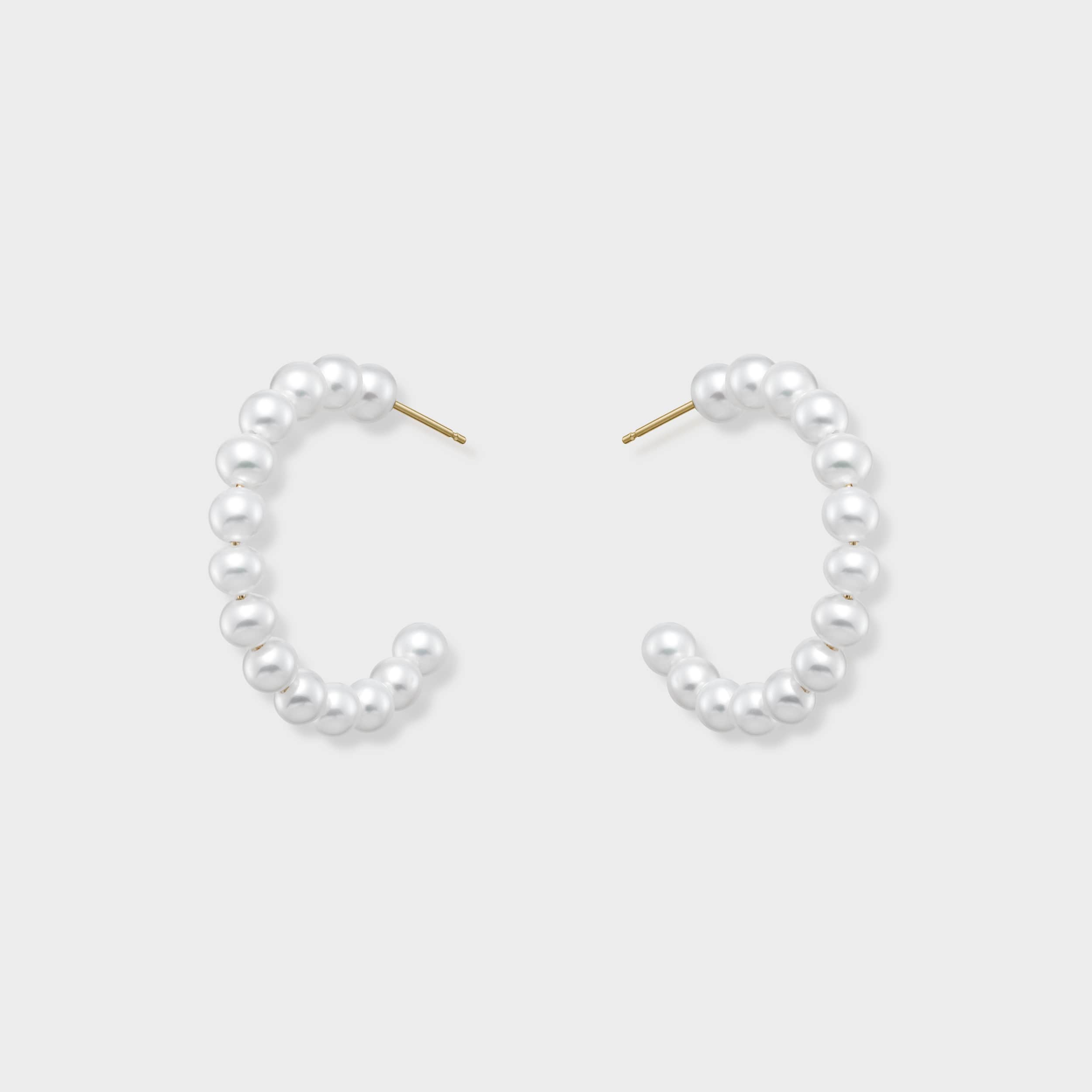 Elegant pearl hoop earrings, meticulously adorned with a continuous row of radiant pearls forming a graceful C-shape. These versatile hoops offer a fresh take on classic pearls, perfect for everyday luxury or special occasions. Make them yours and shine brighter!