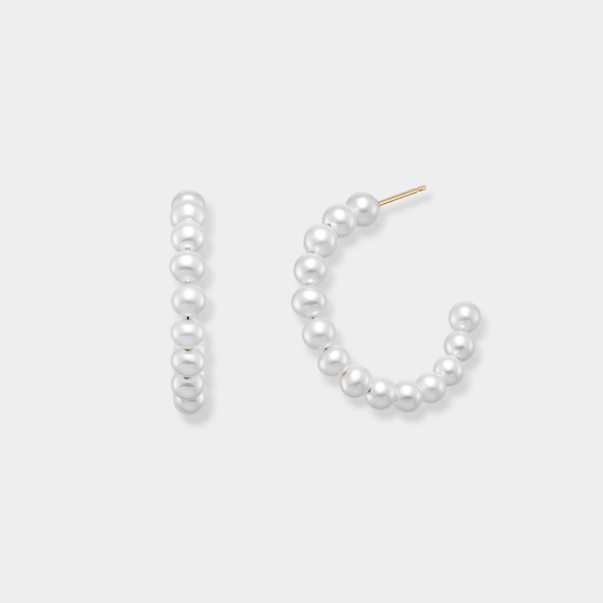 Elegant pearl hoop earrings, meticulously adorned with a continuous row of radiant pearls forming a graceful C-shape. These versatile hoops offer a fresh take on classic pearls, perfect for everyday luxury or special occasions. Make them yours and shine brighter!