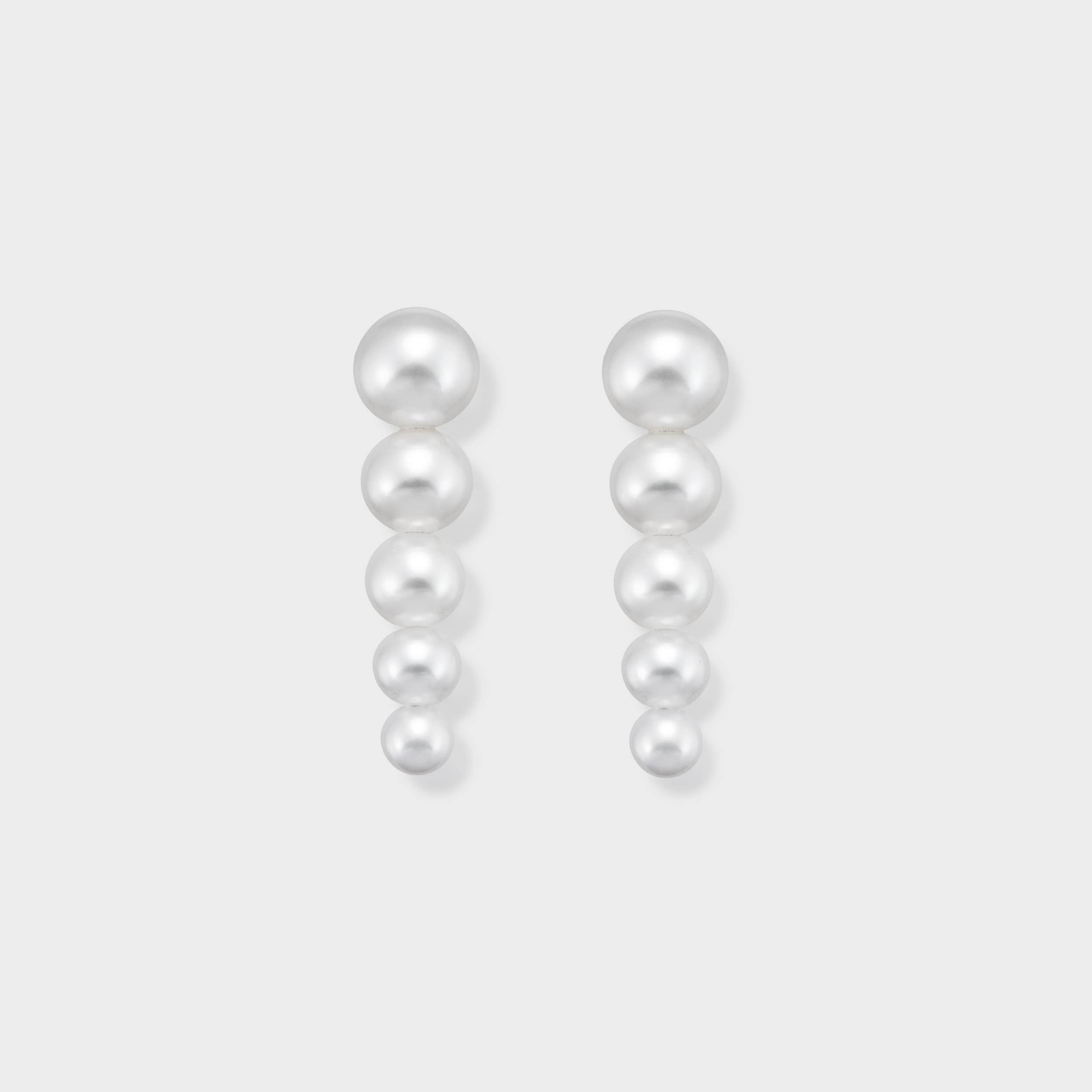 Stunning pearl drop earrings featuring five perfectly graduated pearls, designed to elegantly elongate your look. Elevate any outfit with these timeless and luxurious earrings. Shop now for classic elegance!