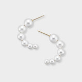 Versatile pearl half-hoop earrings, featuring a delicate row of pearls in a charming C-shape, designed for comfort and captivating style. These stunning earrings are the perfect accessory to elevate your daily elegance. Treat yourself to the timeless beauty of pearls!