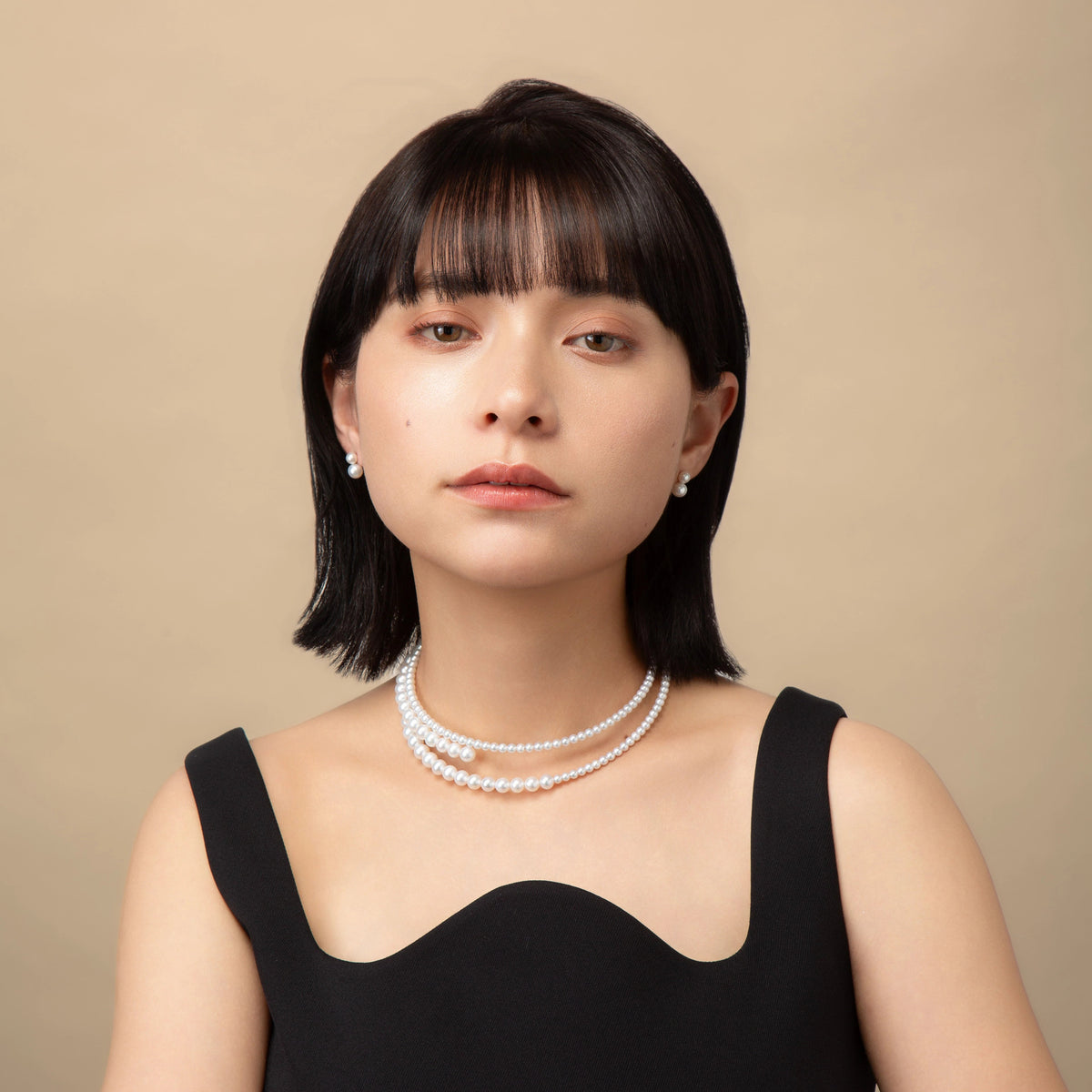 Infinity Necklace worn with a black top, front view