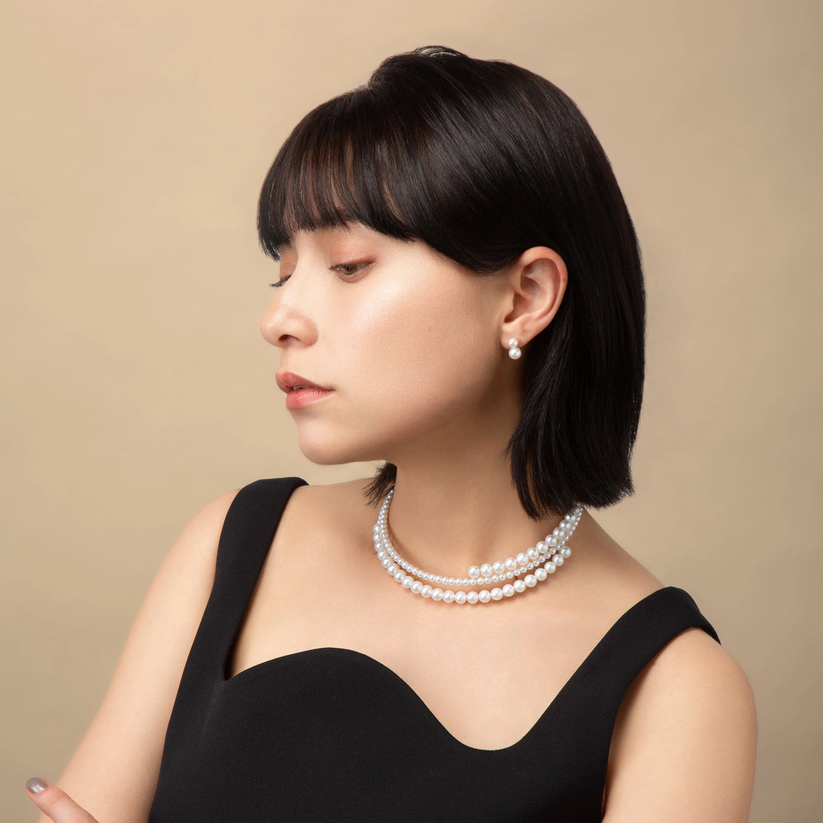 Infinity Necklace worn with a black top, side view