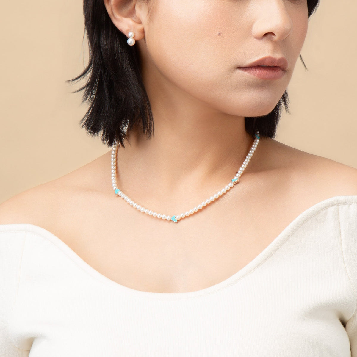 Blue Enamel Heart Pearl Necklace worn with a white top