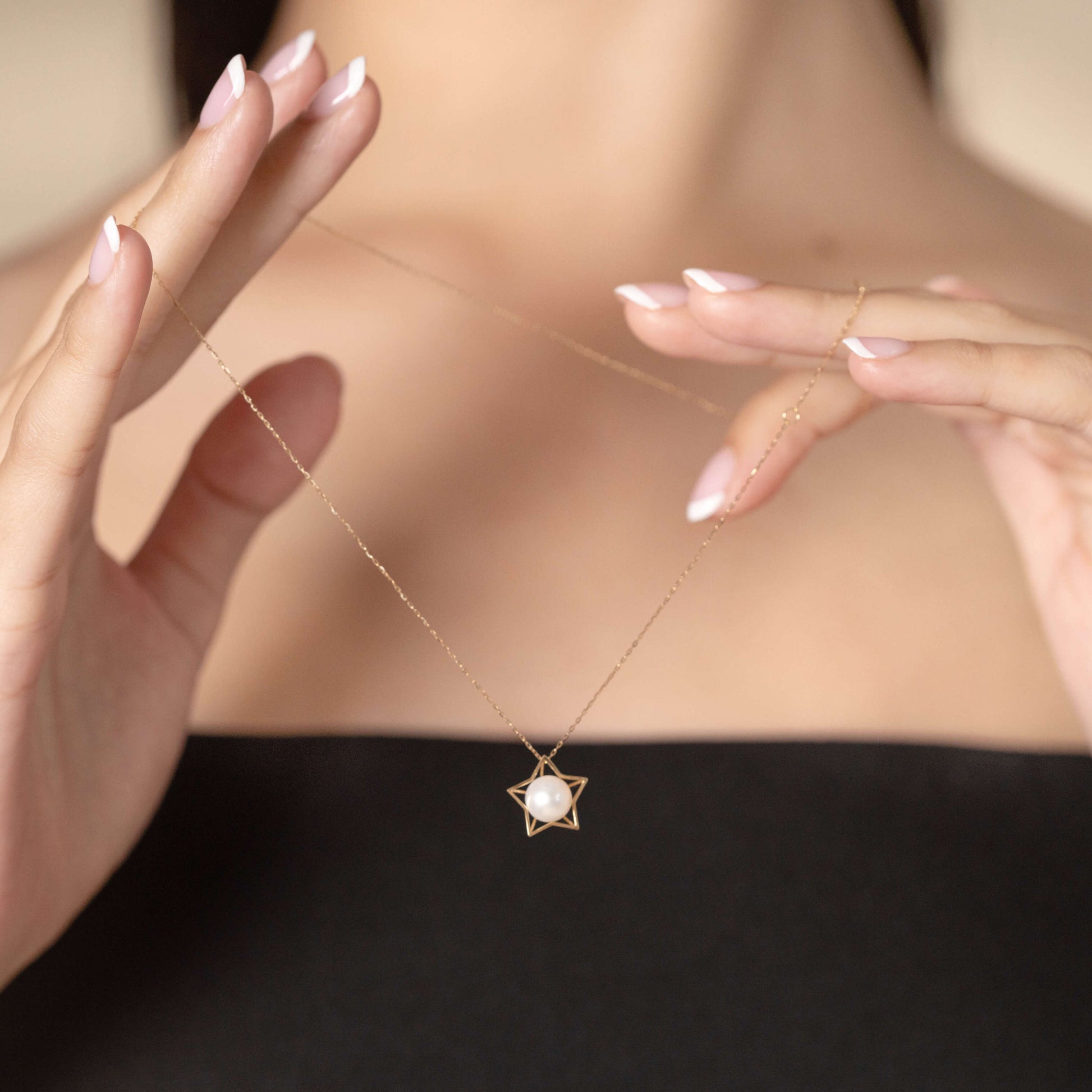 Elevate your style with a woman showcasing a gold star pendant necklace, radiating sophistication.