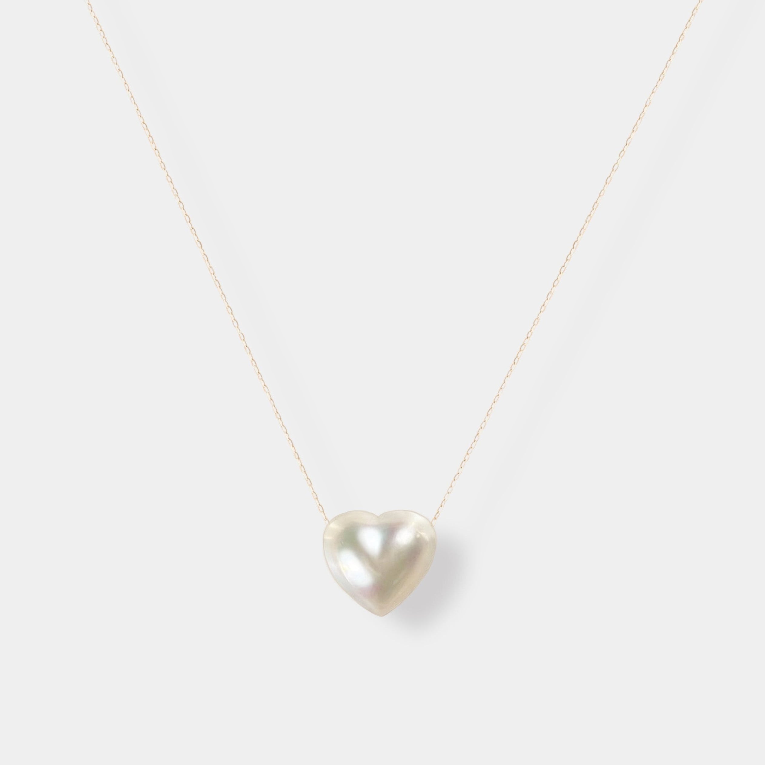 Enhance your elegance with our exquisite Heart Pearl Chain Necklace - a stunning white pearl heart pendant on a delicate gold chain.