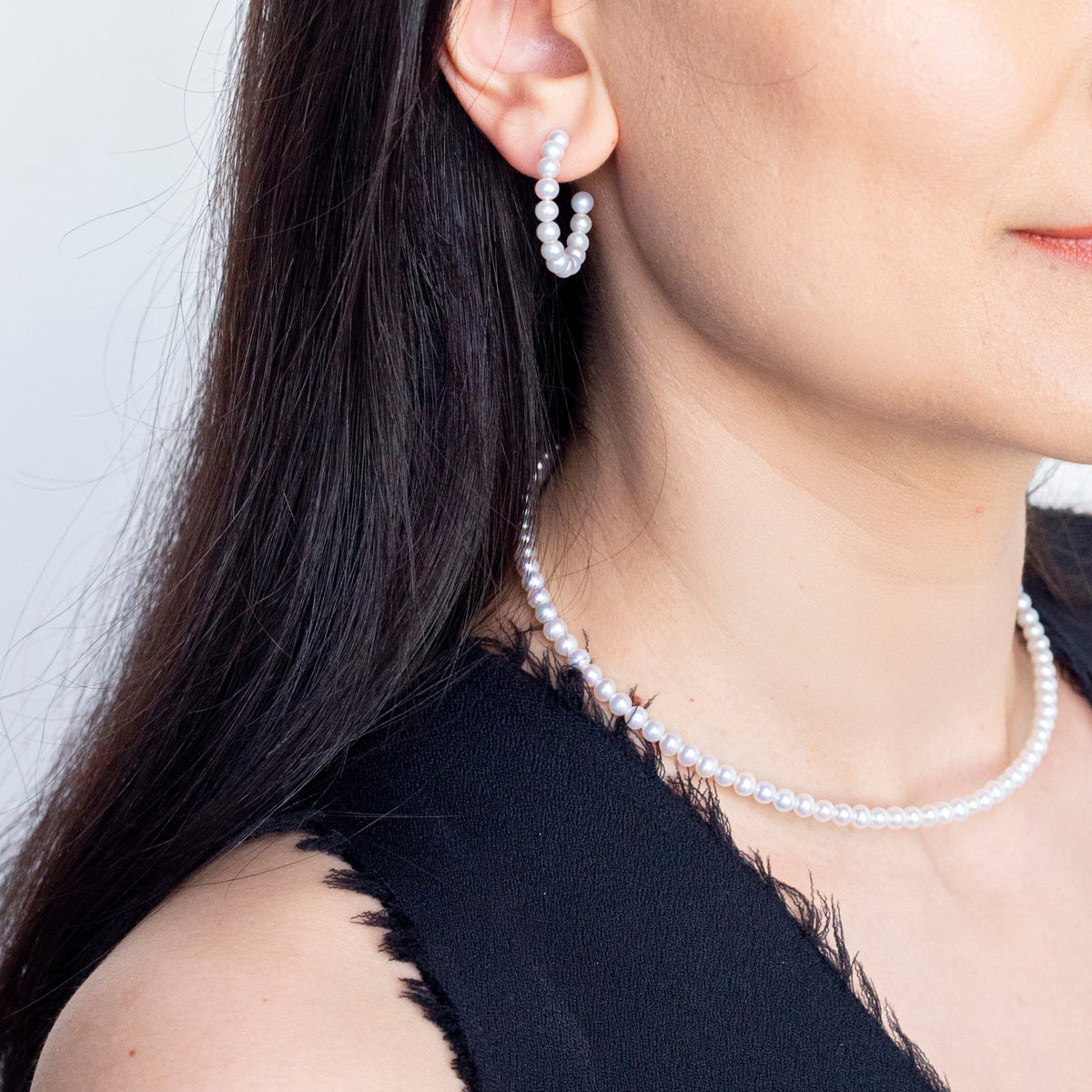 Baby Pearl Hoop Pierce worn with a pearl necklace