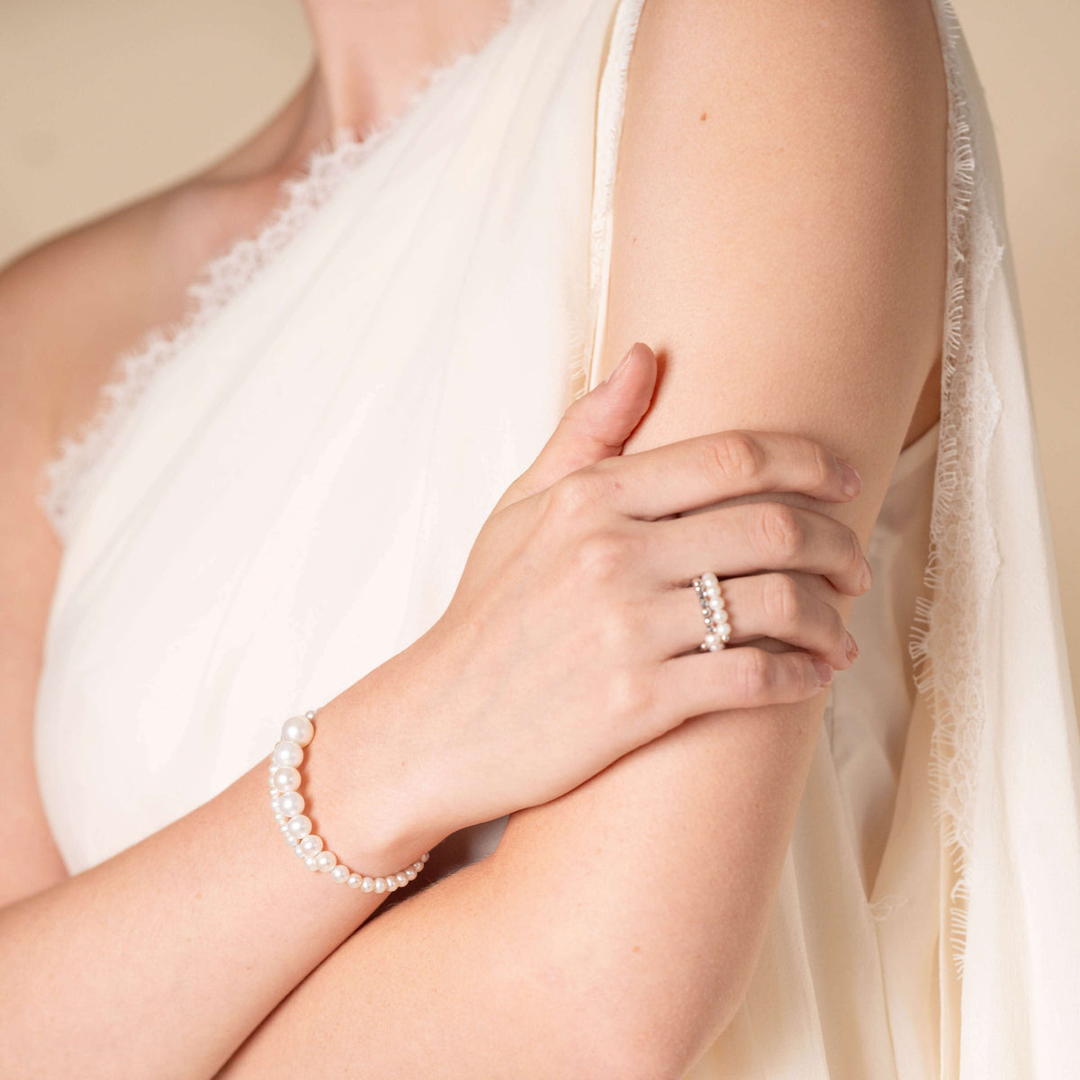Spiral Pearl Bracelet worn on the wrist with a ring