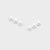 Elevate your look with our Triple Pearl Pierce. Featuring a modern vertical design with three graduated freshwater pearls, these studs offer a chic, architectural twist on a classic favorite. Made in 18K Yellow Gold.