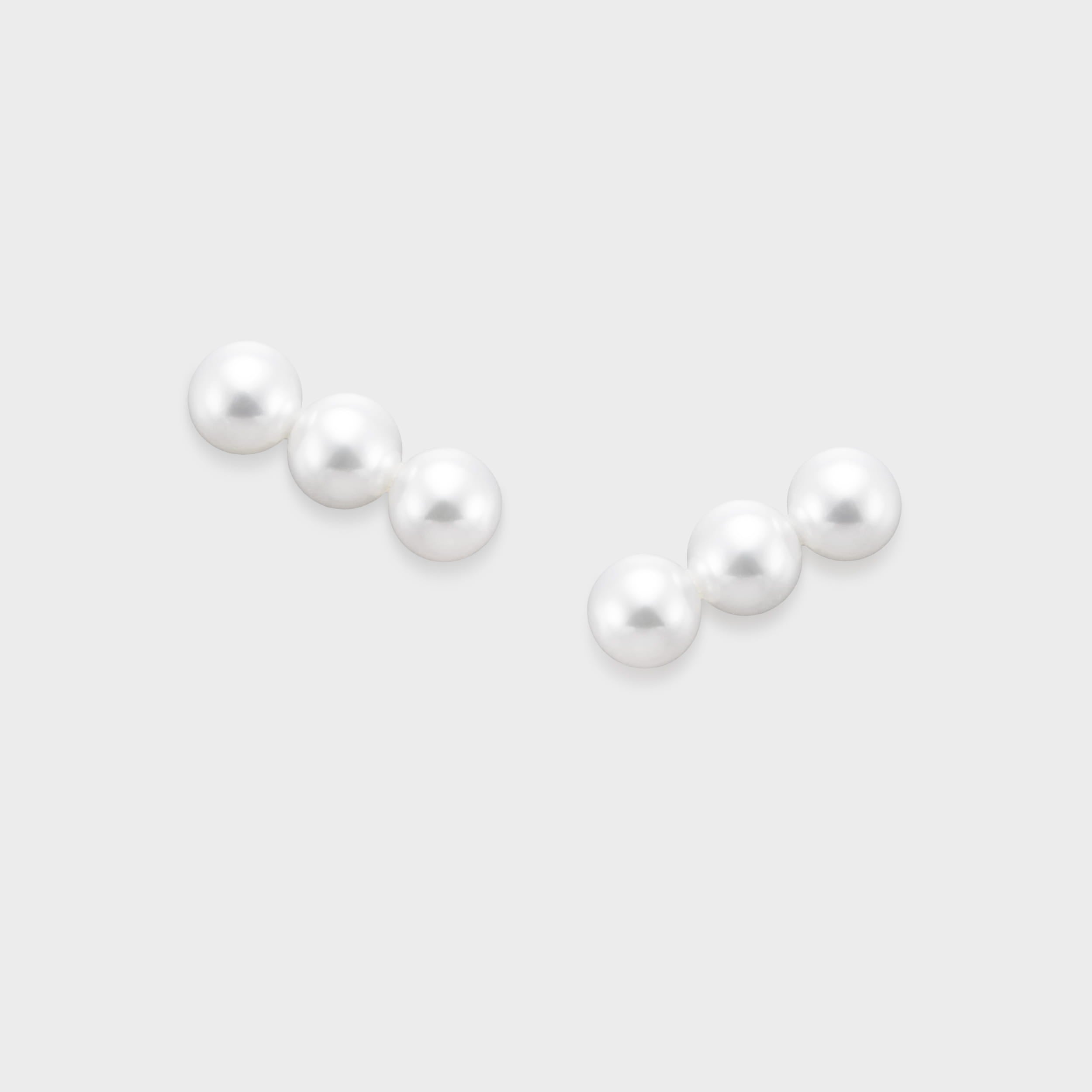 Elevate your look with our Triple Pearl Pierce. Featuring a modern vertical design with three graduated freshwater pearls, these studs offer a chic, architectural twist on a classic favorite. Made in 18K Yellow Gold.