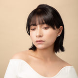 Elevate your look with our Triple Pearl Pierce. Featuring a modern vertical design with three graduated freshwater pearls, these studs offer a chic, architectural twist on a classic favorite. Made in 18K Yellow Gold.