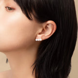 Elevate your look with our Triple Pearl Pierce. Featuring a modern vertical design with three graduated freshwater pearls, these studs offer a chic, architectural twist on a classic favorite. Made in 18K Yellow Gold.