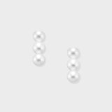 Elevate your look with our Triple Pearl Pierce. Featuring a modern vertical design with three graduated freshwater pearls, these studs offer a chic, architectural twist on a classic favorite. Made in 18K Yellow Gold.
