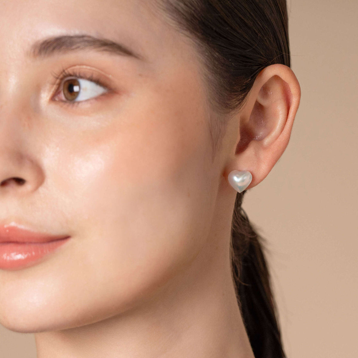 Heart Pearl Stud Pierce worn on the ear, close-up