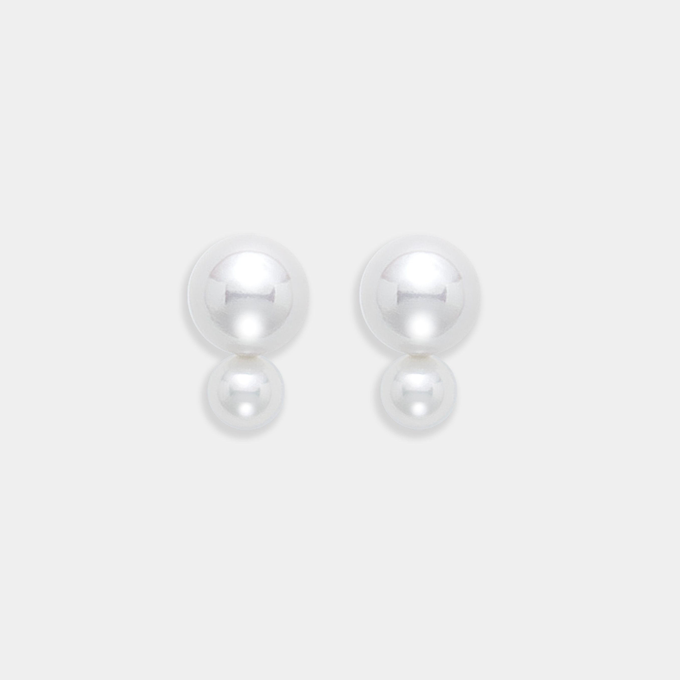Two exquisite freshwater pearl earrings set in 18K yellow gold, elegantly presented on a bright white background.
