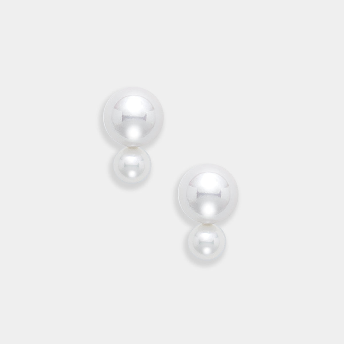 Fancy Pearl Pierce: two freshwater pearls of different sizes on 18K yellow gold posts