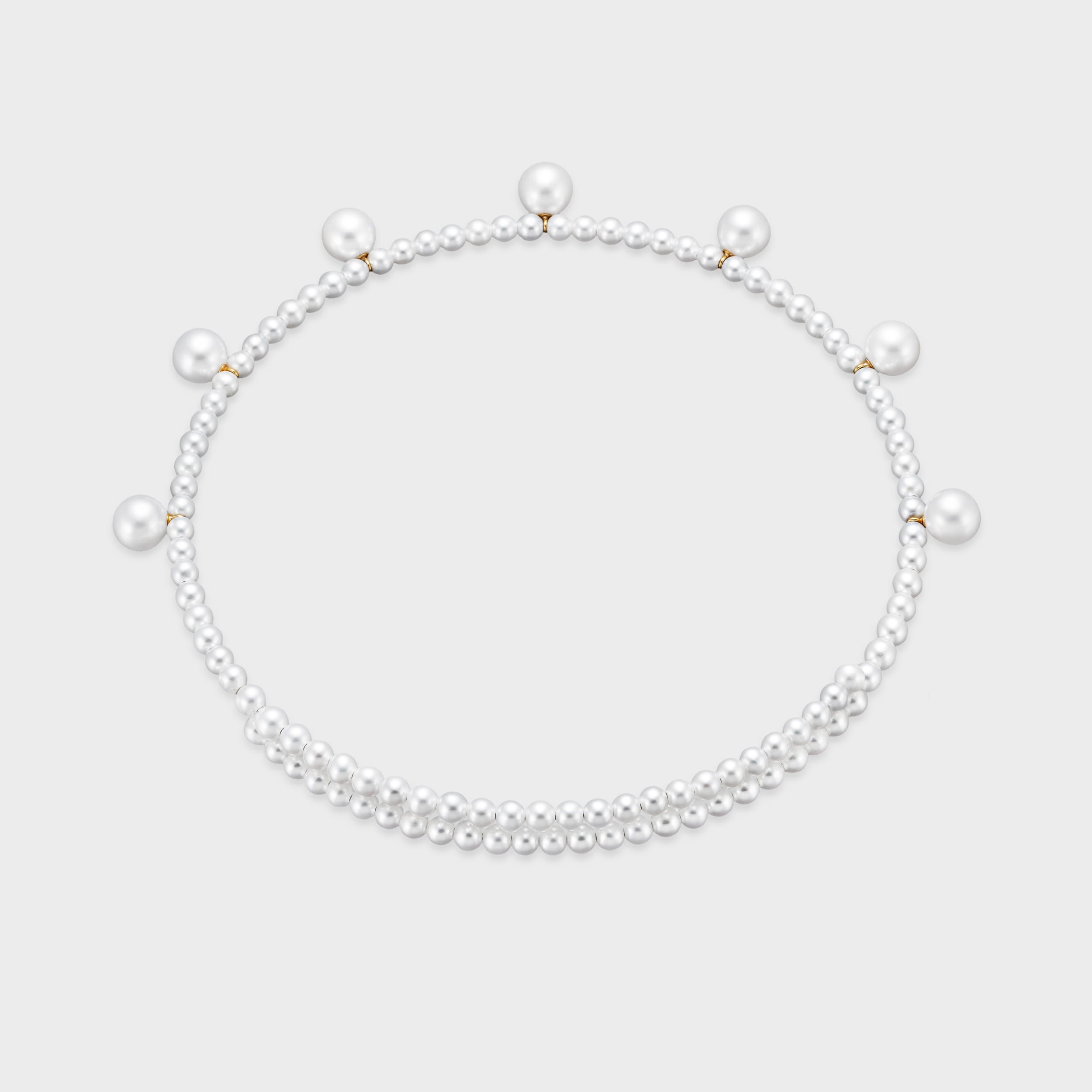 A playful twist on a classic. Our Pearl Dot Freshwater Choker features radiant larger freshwater pearls suspended from a delicate strand. Modern, feminine, and perfect for layering. Made in 18K yellow gold.