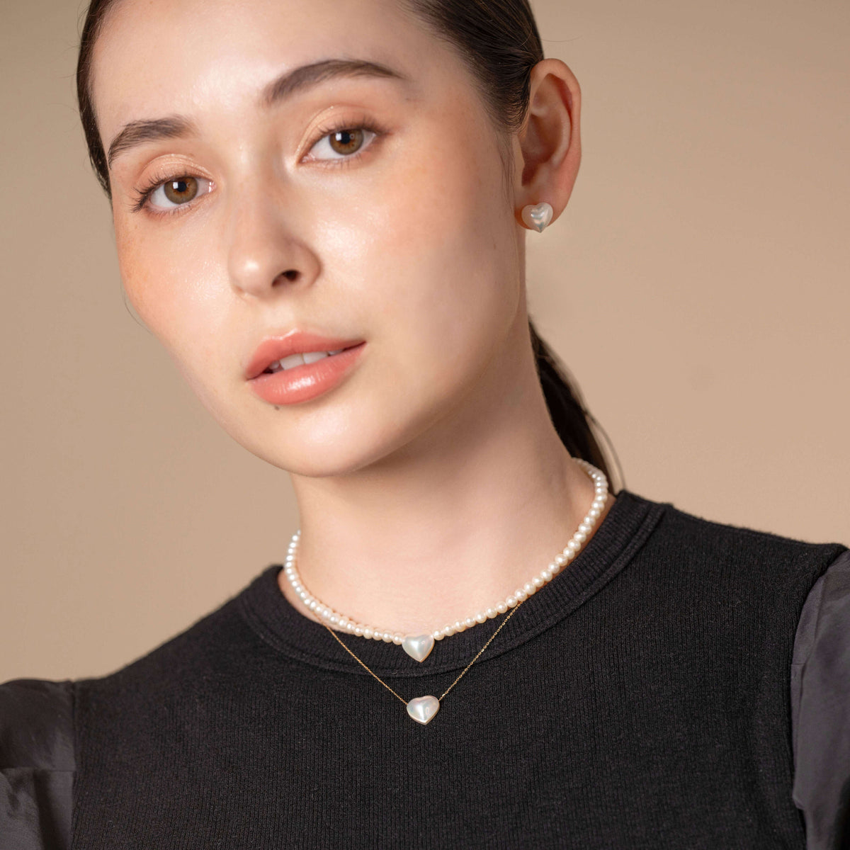 Heart Pearl Necklace worn with a black top