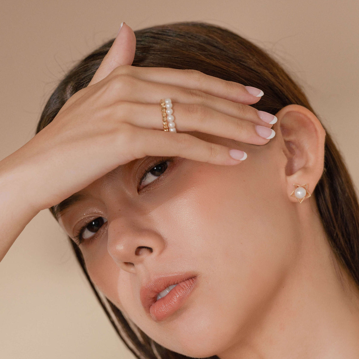 Spiral Pearl Gold Ring worn on the finger, alternate view