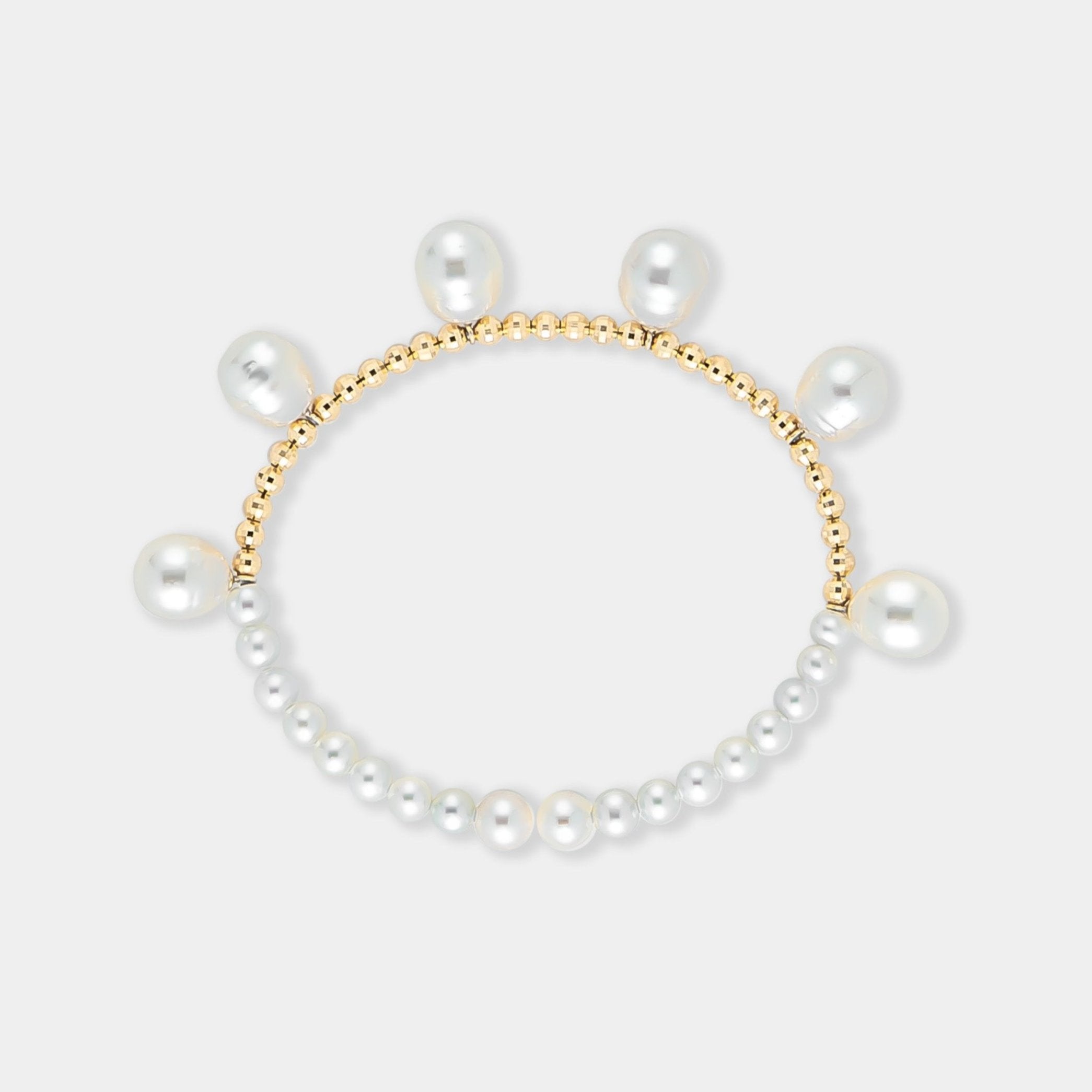 Elegant pearl bracelet with gold beads on a white background. Perfect for adding a touch of sophistication to any outfit.