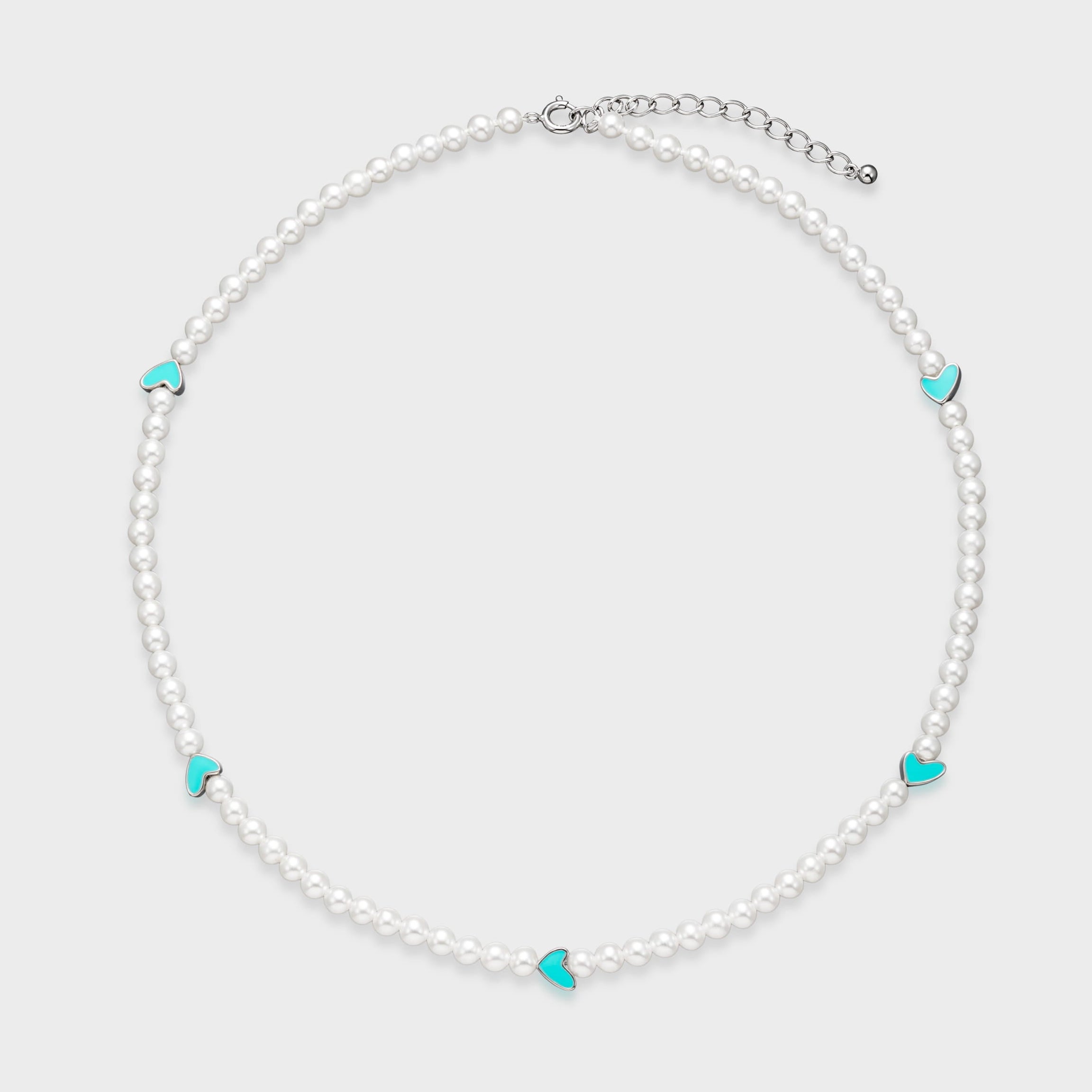 Delicate white pearl necklace with five turquoise enamel heart charms spaced evenly around the strand on a light gray background.