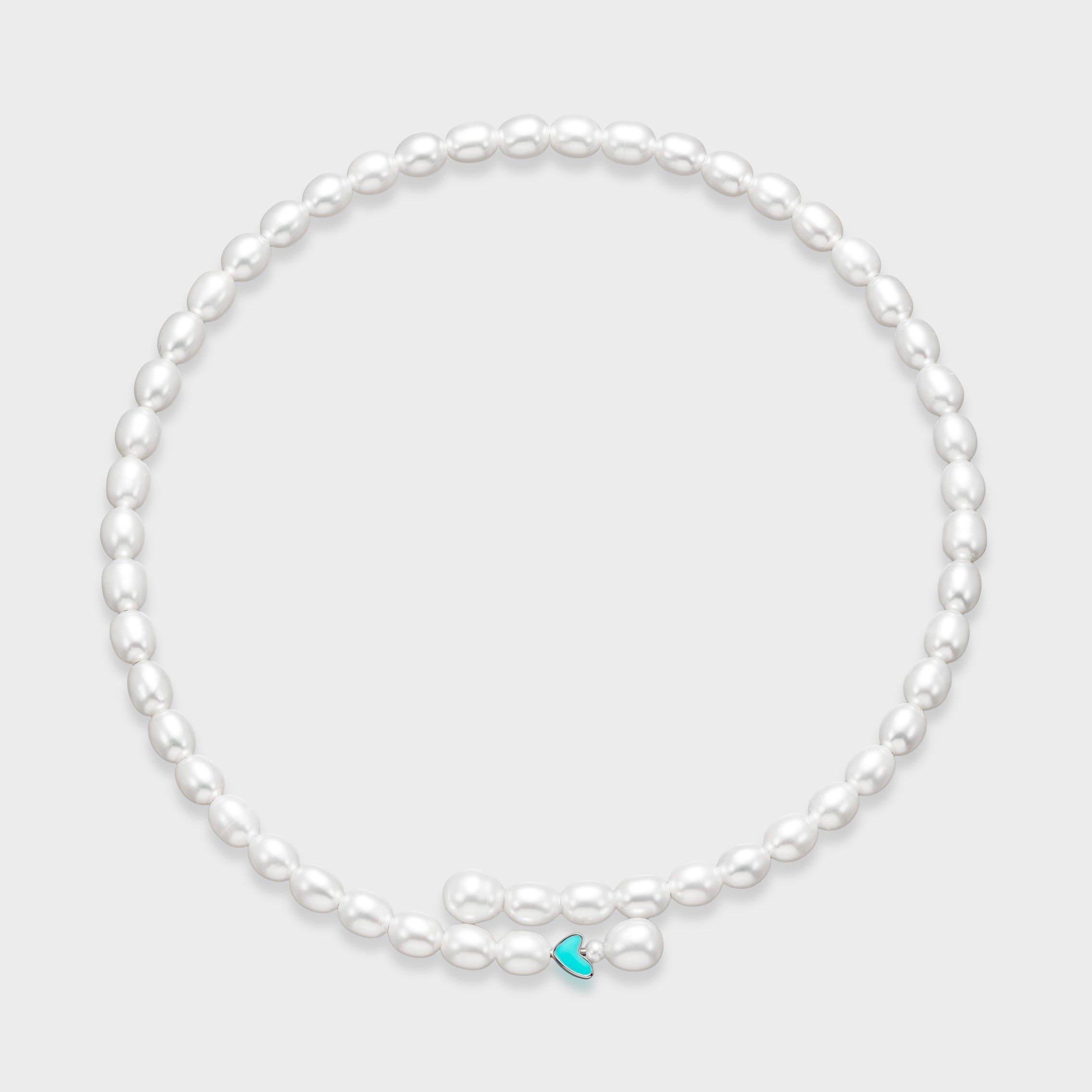 White oval pearl necklace with small turquoise enamel heart charm centered at the front on a light gray background